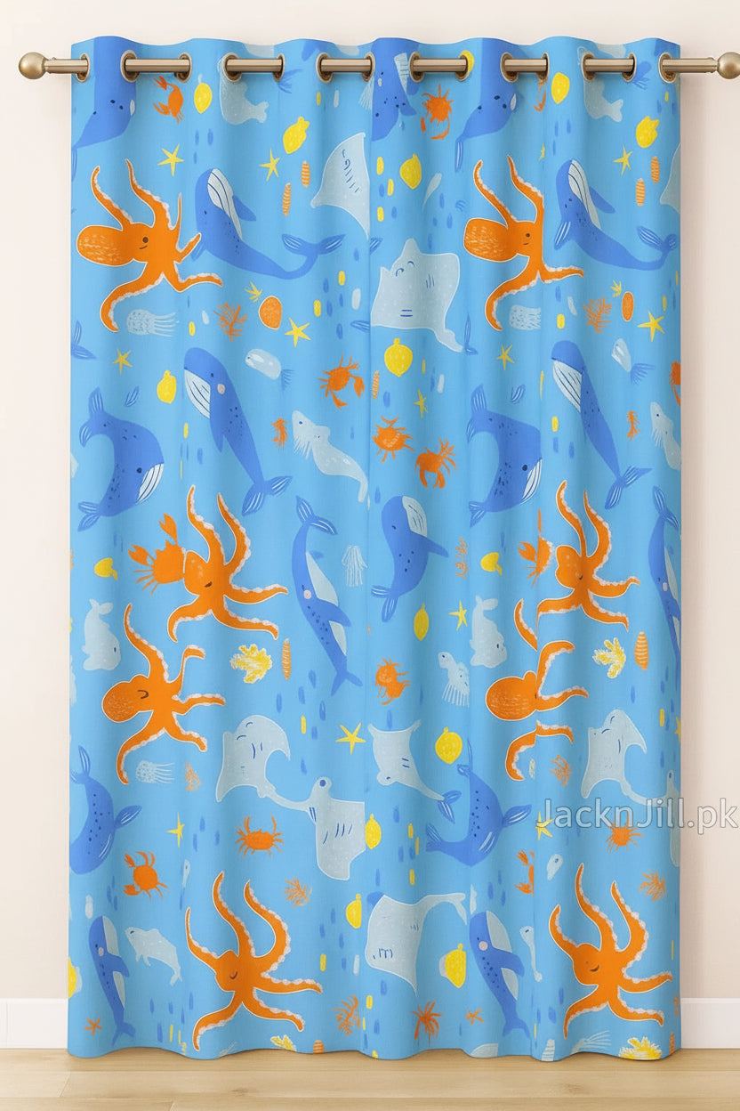 Blue kids curtain with colorful ocean animal prints including whales, octopuses, stingrays, and crabs.