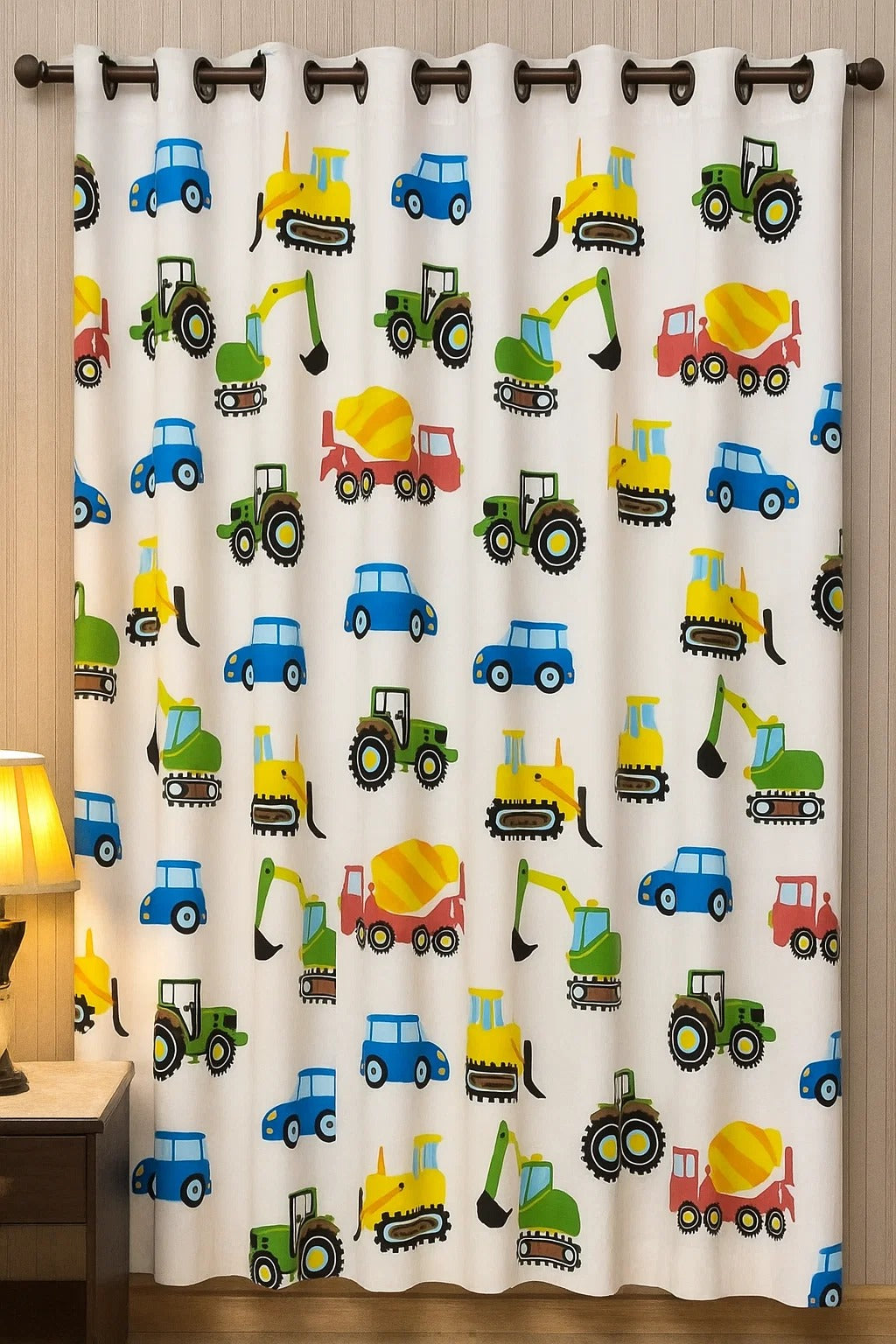 White kids curtain with colorful cartoon cars, tractors, excavators, and cement trucks printed all over.