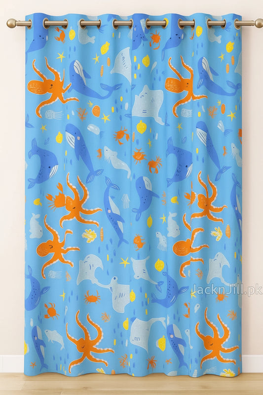 Blue kids curtain with colorful ocean animal prints including whales, octopuses, stingrays, and crabs.